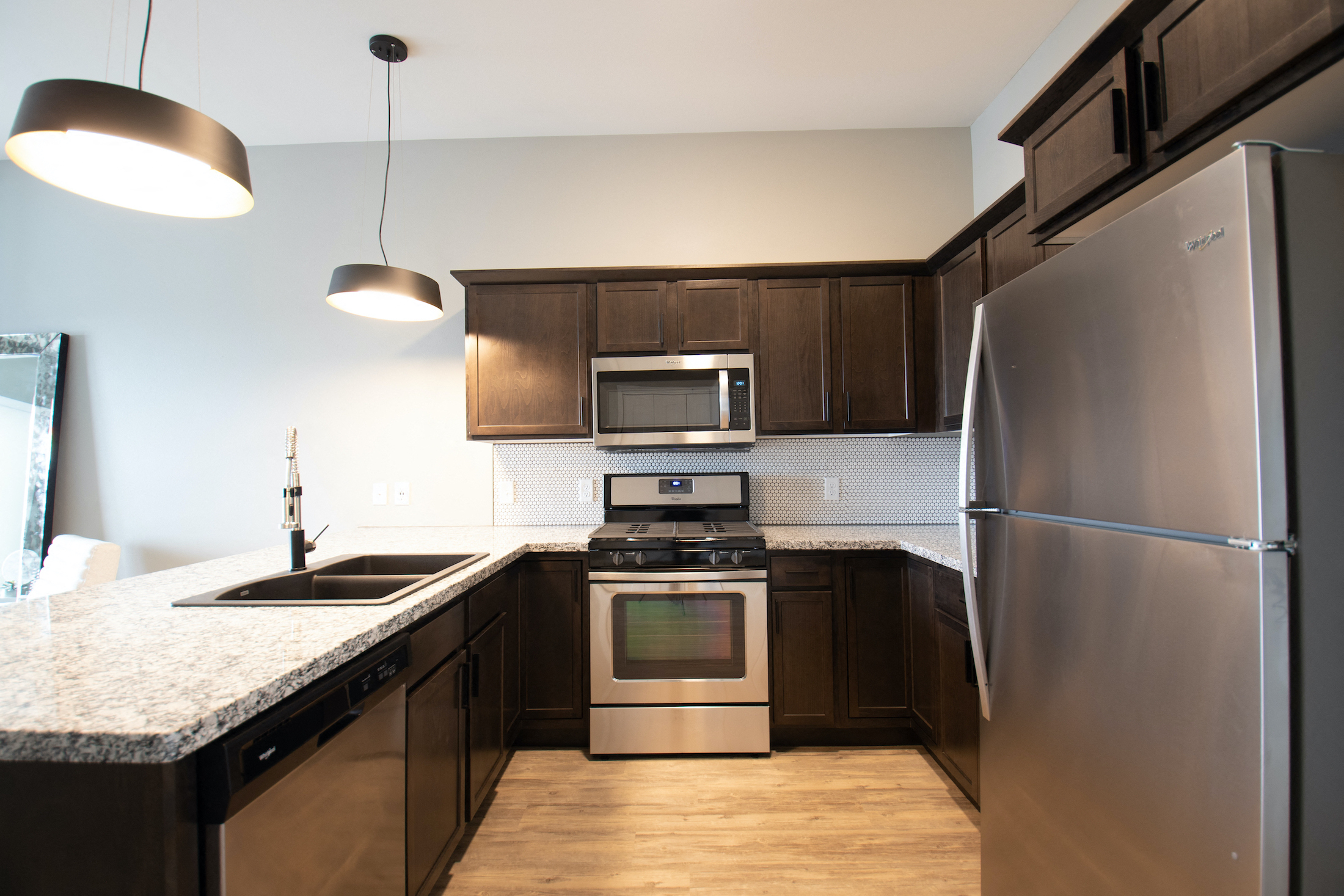 a kitchen with stainless steel appliances and a granite counter top