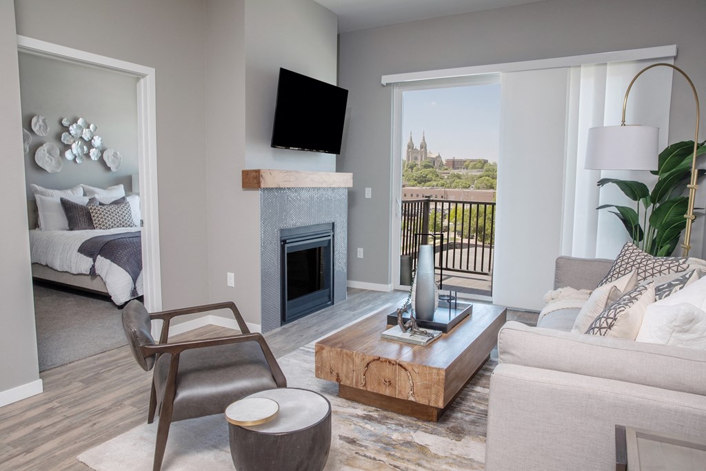 a living room with a fireplace and a view of the city