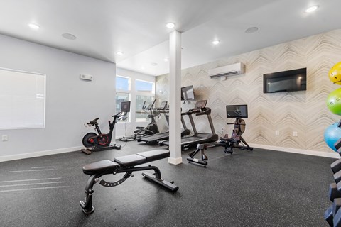 A spacious home gym with a variety of exercise equipment.