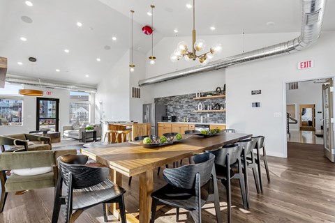 A modern dining room with a wooden table and chairs.
