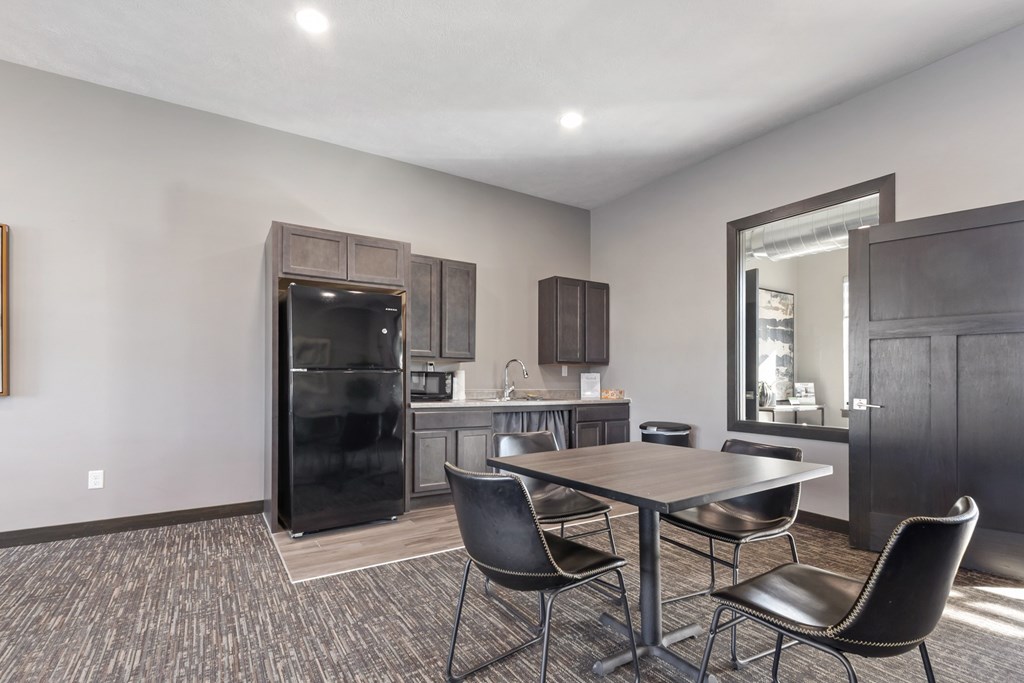 A modern kitchen with a dining table and chairs.