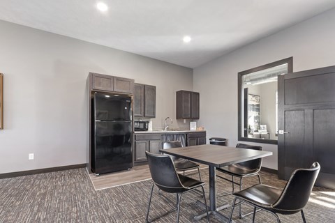 A modern kitchen with a dining table and chairs.