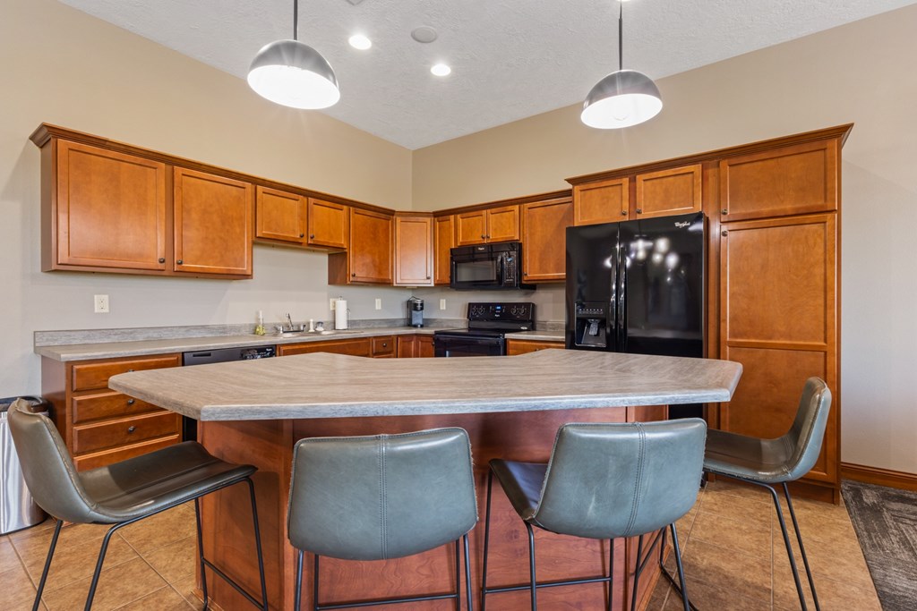 A kitchen with a table and chairs.