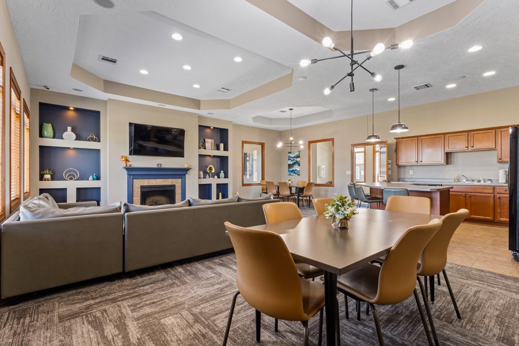 A modern dining room with a large table and chairs.