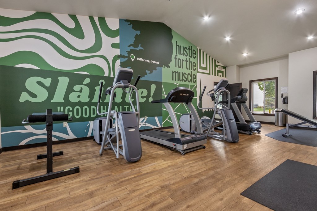 A gym with a green wall and a sign that says "Slainte! Good Health!"