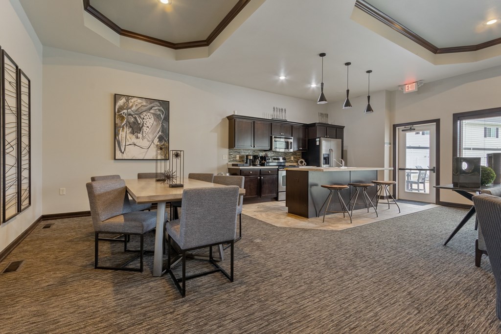 A modern kitchen with a dining table and chairs.