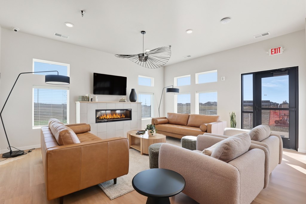 A living room with a fireplace and a flat screen TV.