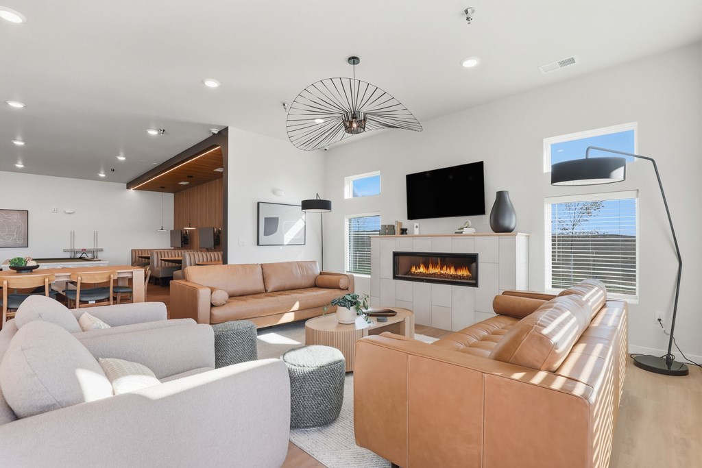 A modern living room with a fireplace and a television.