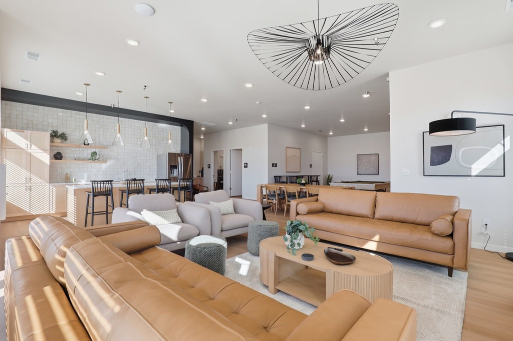 A modern living room with a large sectional sofa and a coffee table.