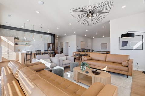 A modern living room with a large sectional sofa and a coffee table.