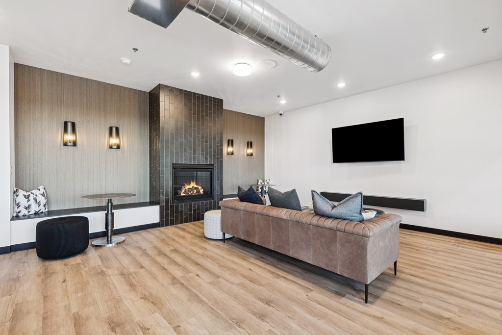 A modern living room with a fireplace and a large couch.