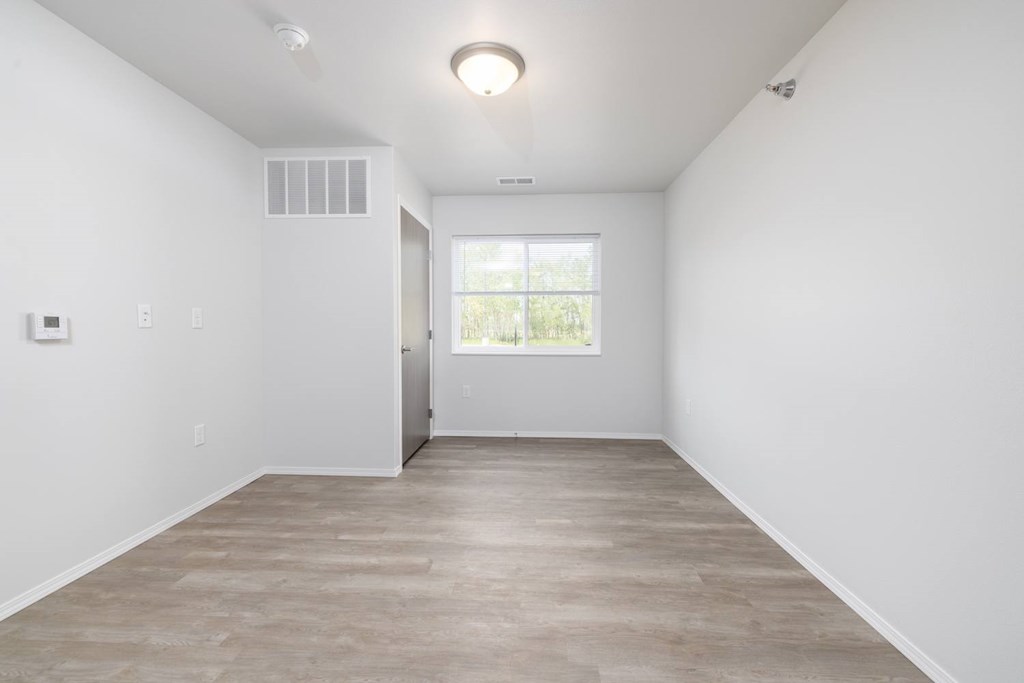 A room with a window and a door.