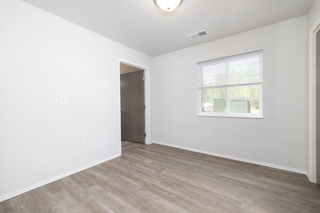 A room with a window and a door.