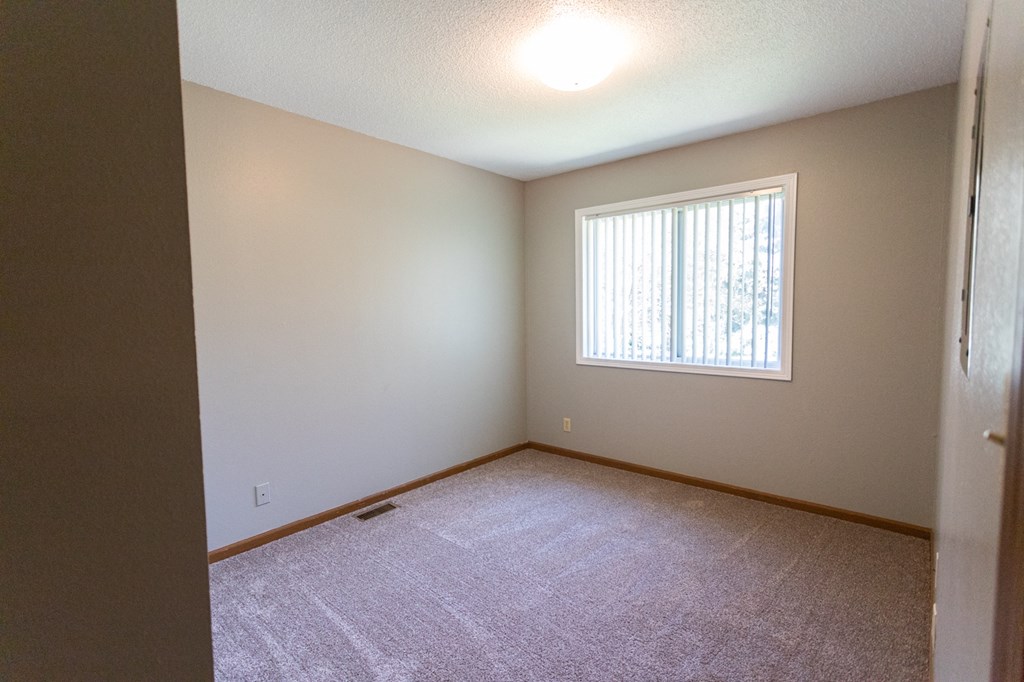 the living room of an empty house with a window