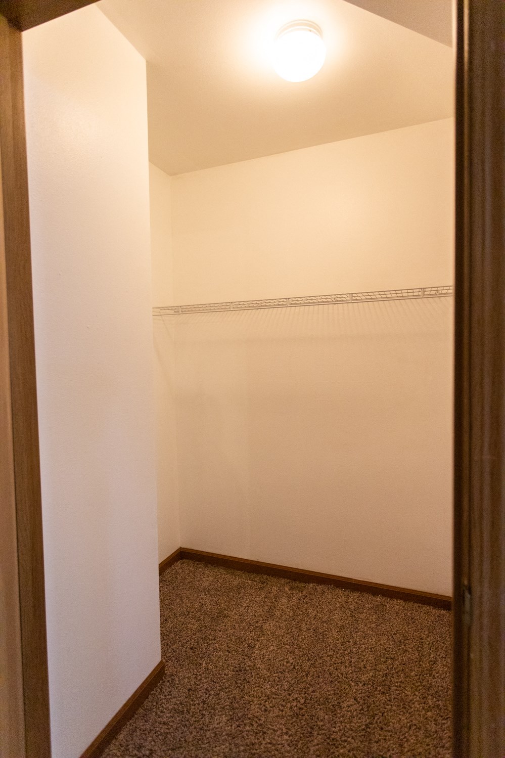 an empty room with a white wall and a door