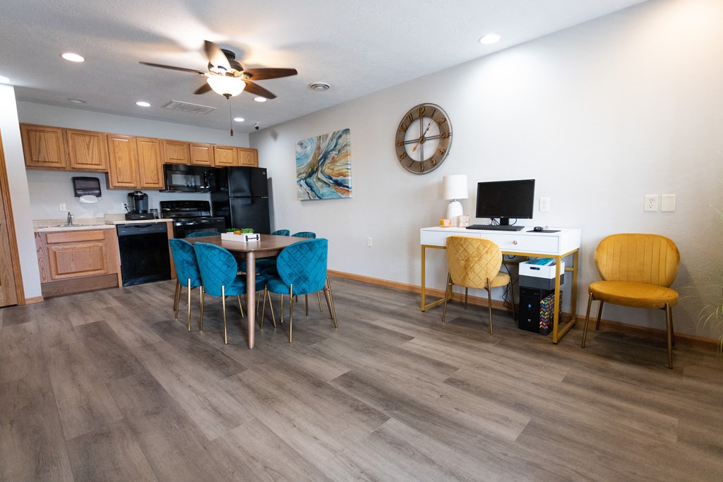 a living room with a dining room table and chairs and a kitchen