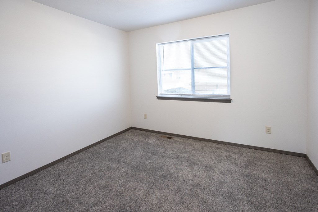 room with carpet and window in a white room