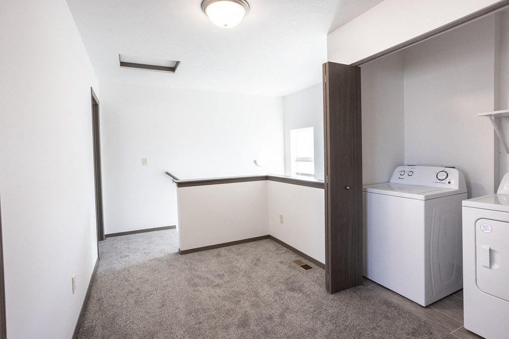 an empty laundry room with washer and dryer in a new home