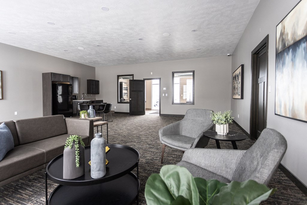 a living room with couches and chairs and a table