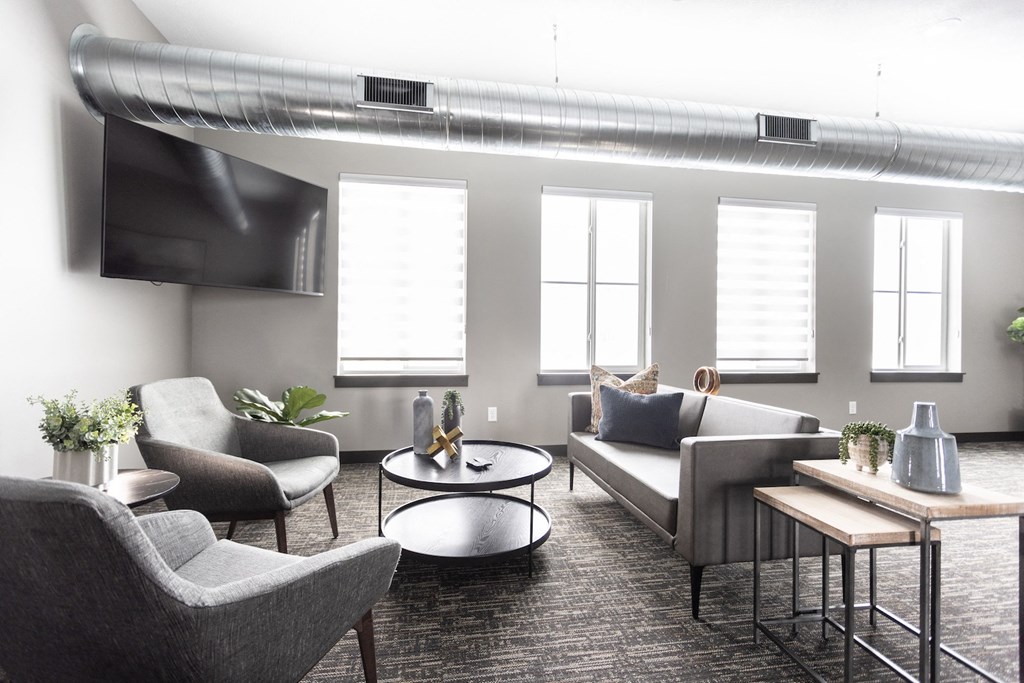 a living room with couches and chairs and a table