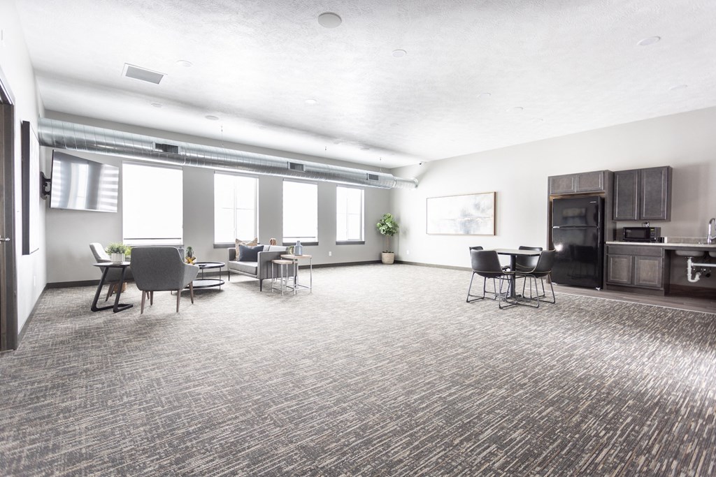 a large living room with a table and chairs and a kitchen