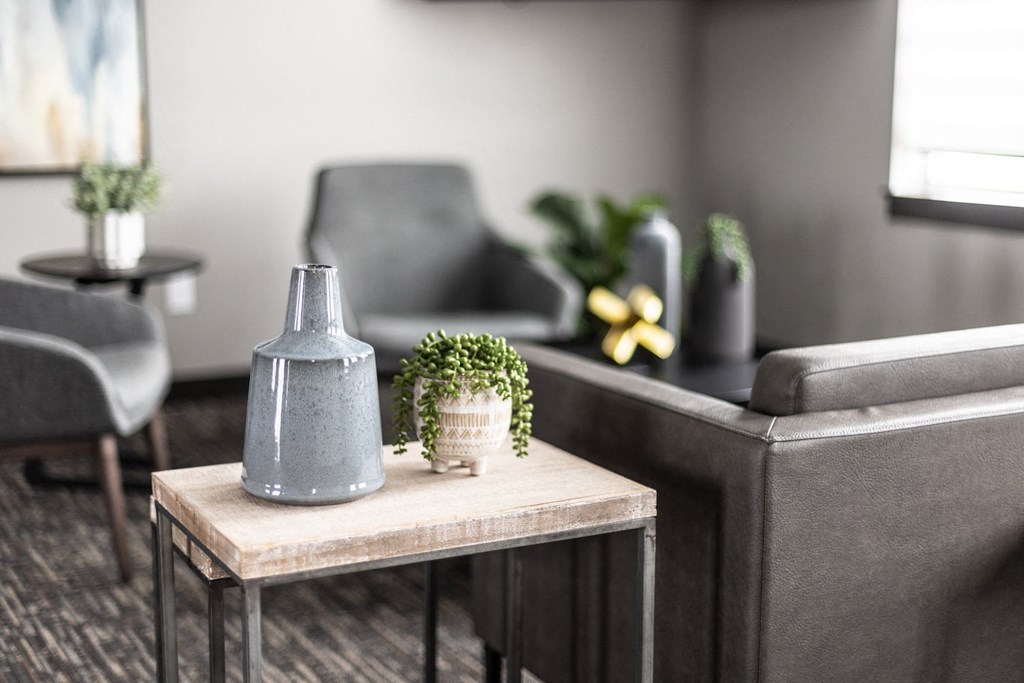 a living room with a couch and a table with a plant