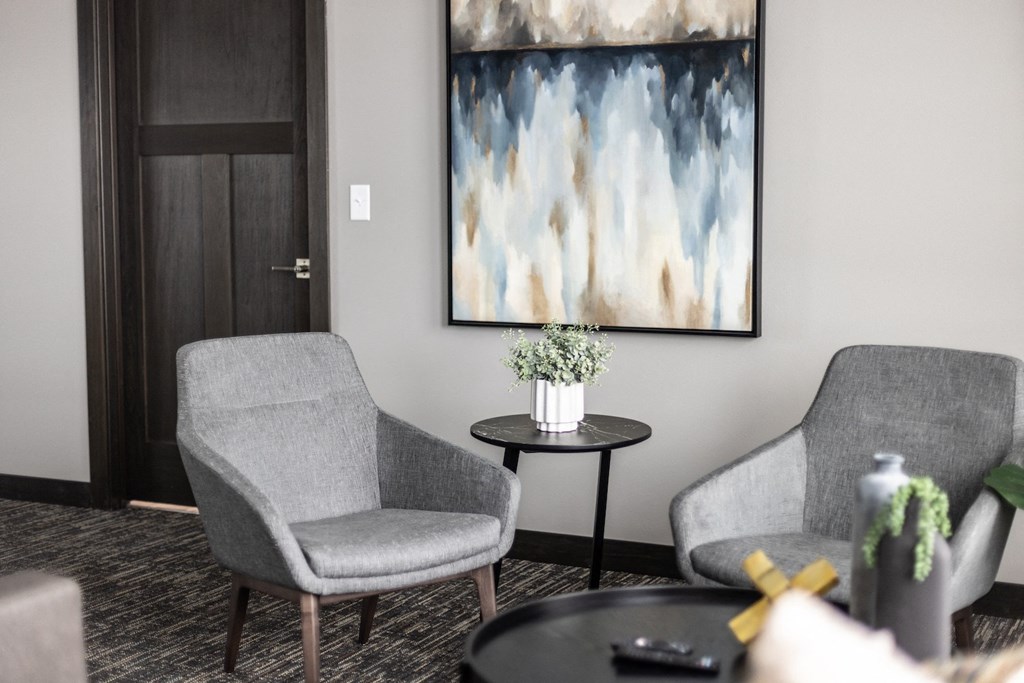 a living room with two chairs and a table