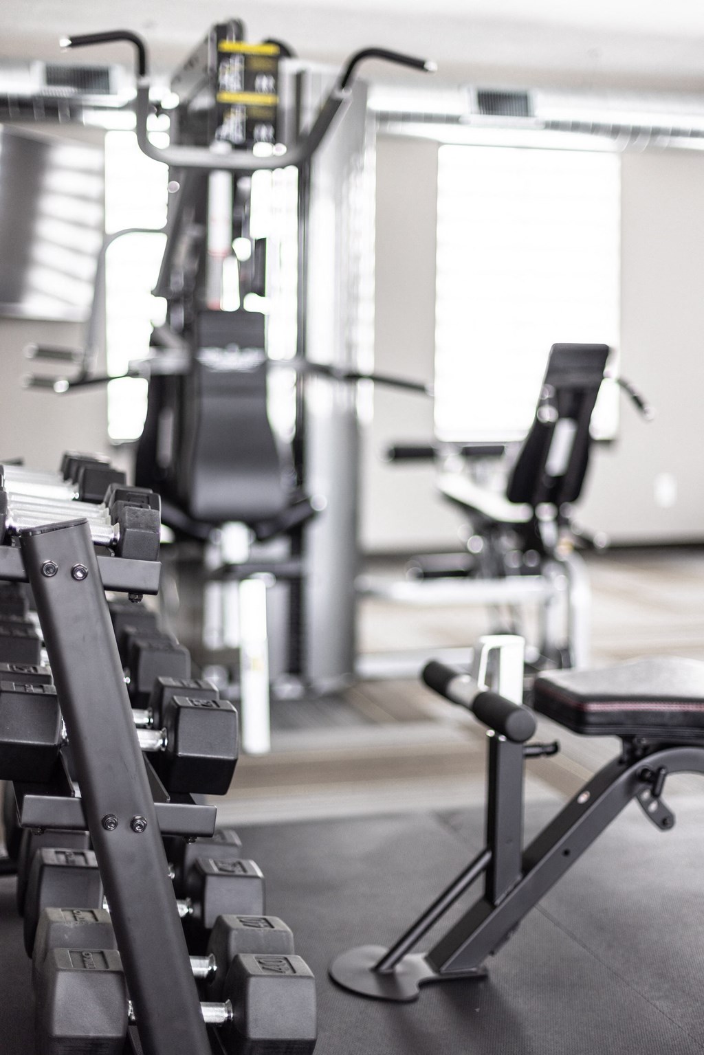 a gym with cardio machines and weights