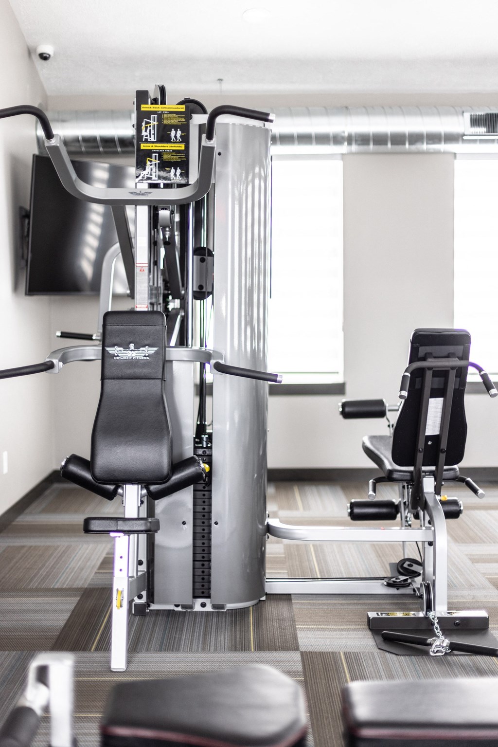 a gym with machines and chairs in it
