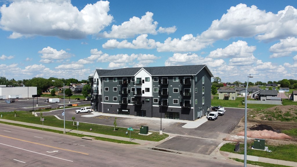 an aerial view of an apartment building on a city street