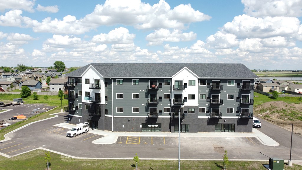 an aerial view of an apartment building in a parking lot