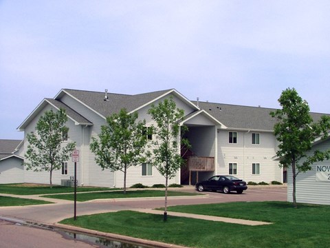 a large white building with a car parked in front of it