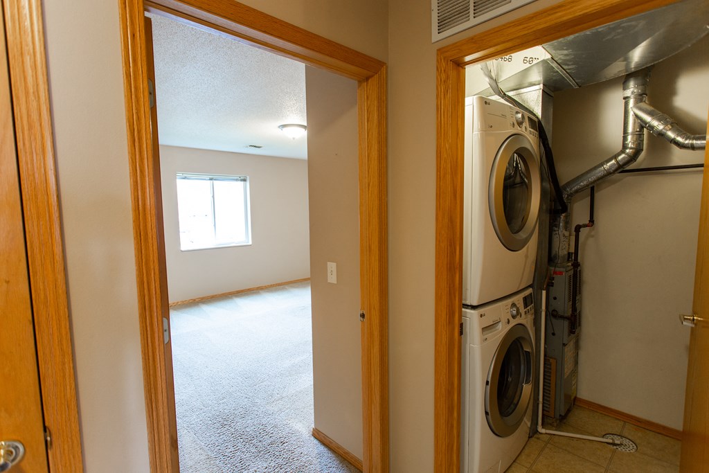 an empty laundry room with a washer and dryer in it