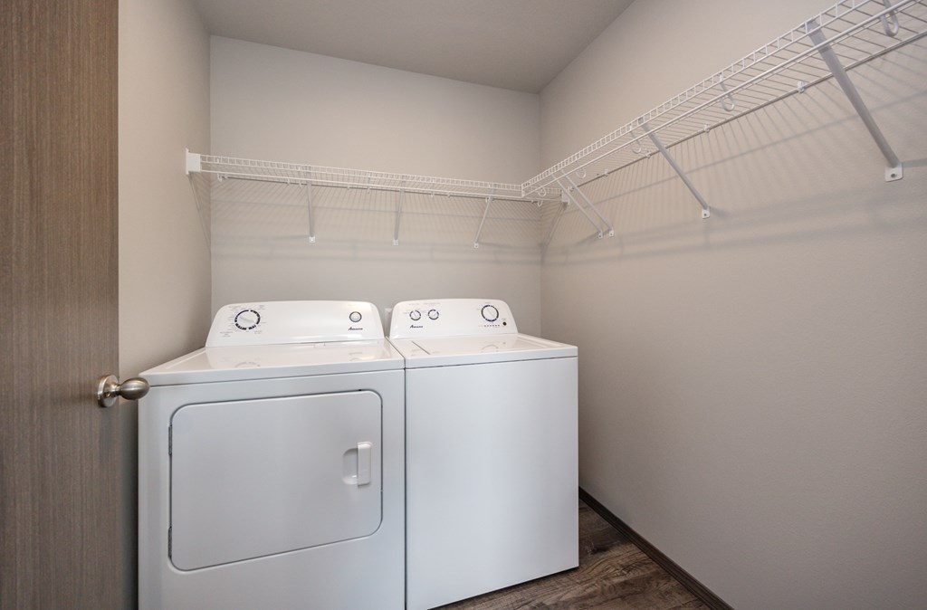 Two washing machines in a small laundry room.