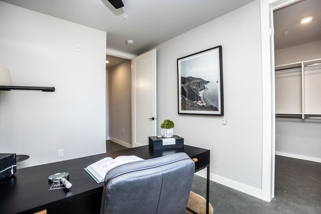 a home office with a desk and a chair