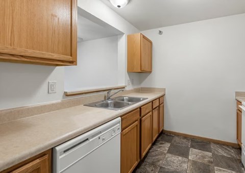A kitchen with a washer and dryer built in to the cabinetry.