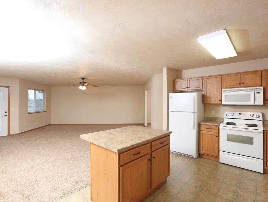 a kitchen with white appliances and a counter top
