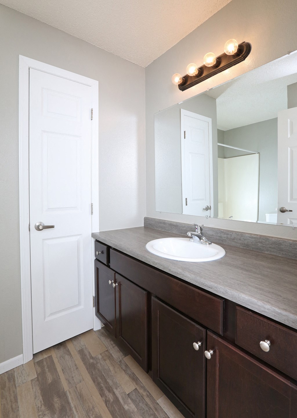 an empty bathroom with a sink and a mirror