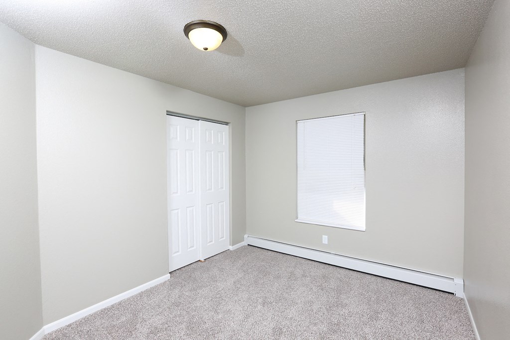 an empty room with a door and a window