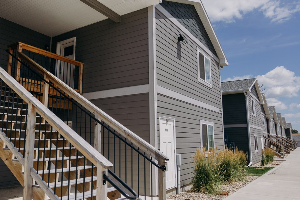 a row of houses with stairs in front of them