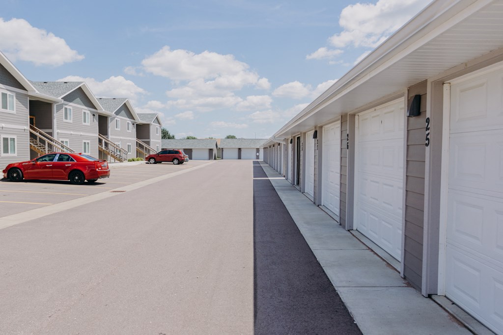 a row of garages with cars parked in front of them