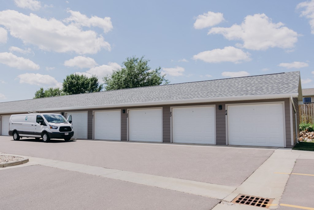 a van parked in front of a building with white garage doors