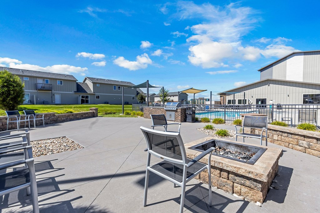 A patio area with a fire pit and seating area.