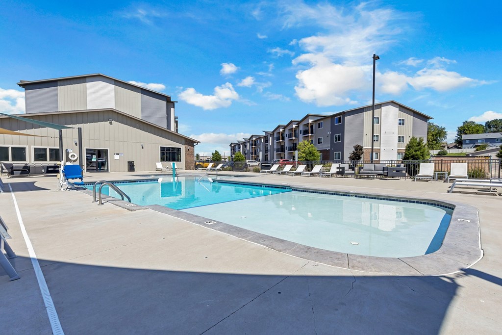 A swimming pool in a sunny outdoor setting.