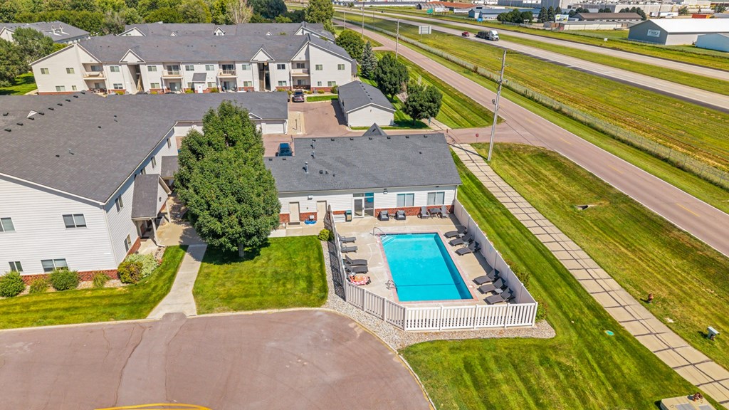 A large white house with a pool in the backyard.