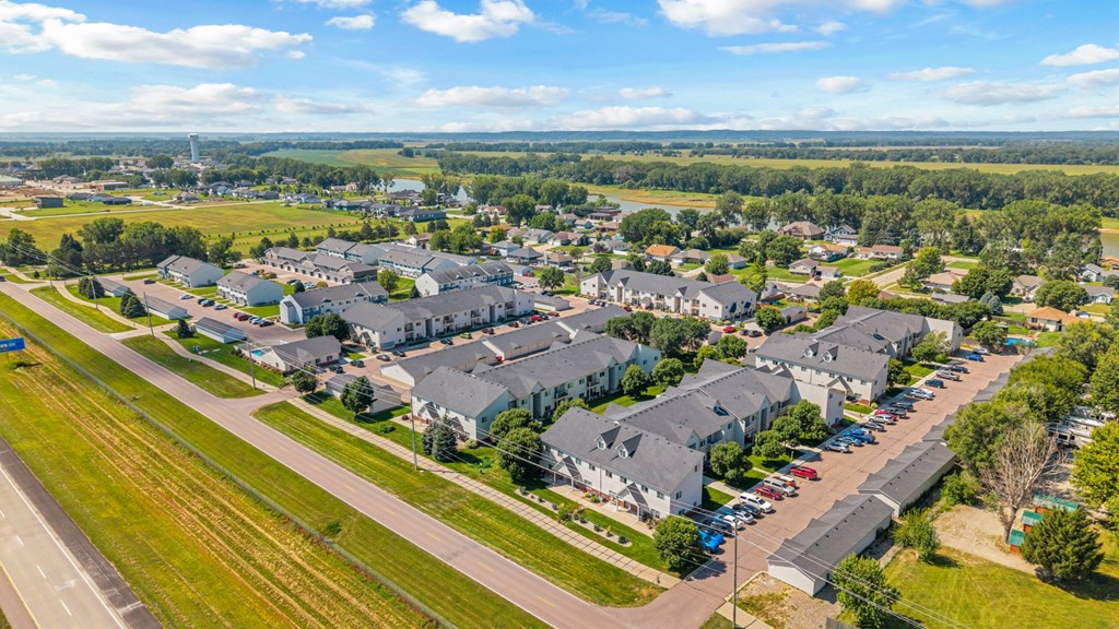 A bird's eye view of a residential area with houses and cars.