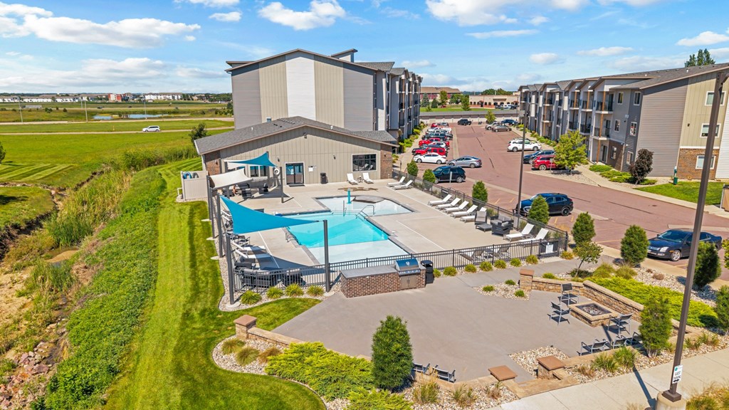 A large building with a pool in front of it.