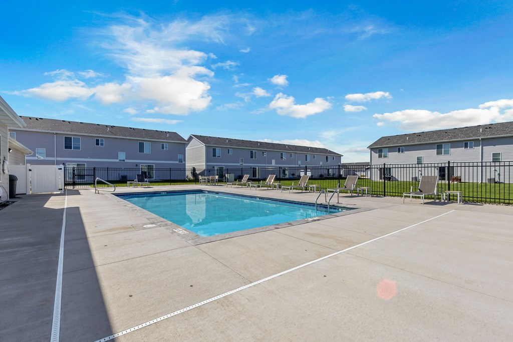 A swimming pool in a sunny outdoor setting.