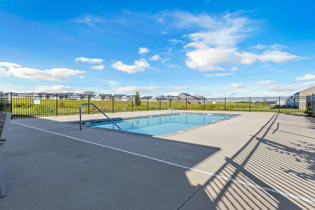 A sunny day at the pool with a clear blue sky.