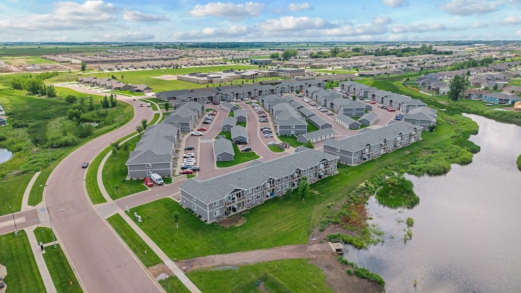 A bird's eye view of a residential area with houses and a river.